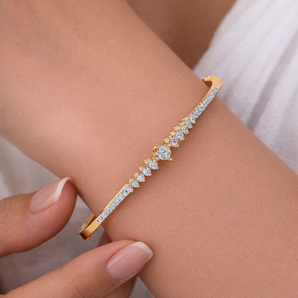 Gold bracelet with diamonds on a wrist against a neutral background