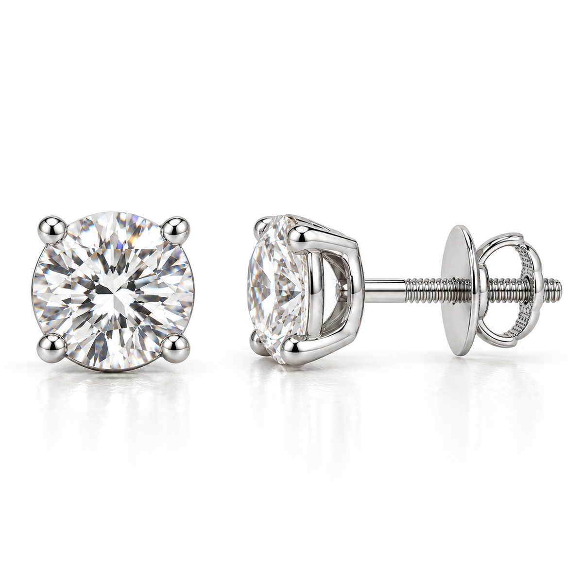 A pair of round-cut diamond stud earrings in a silver four-prong setting, shown from the front and side on a reflective white surface.