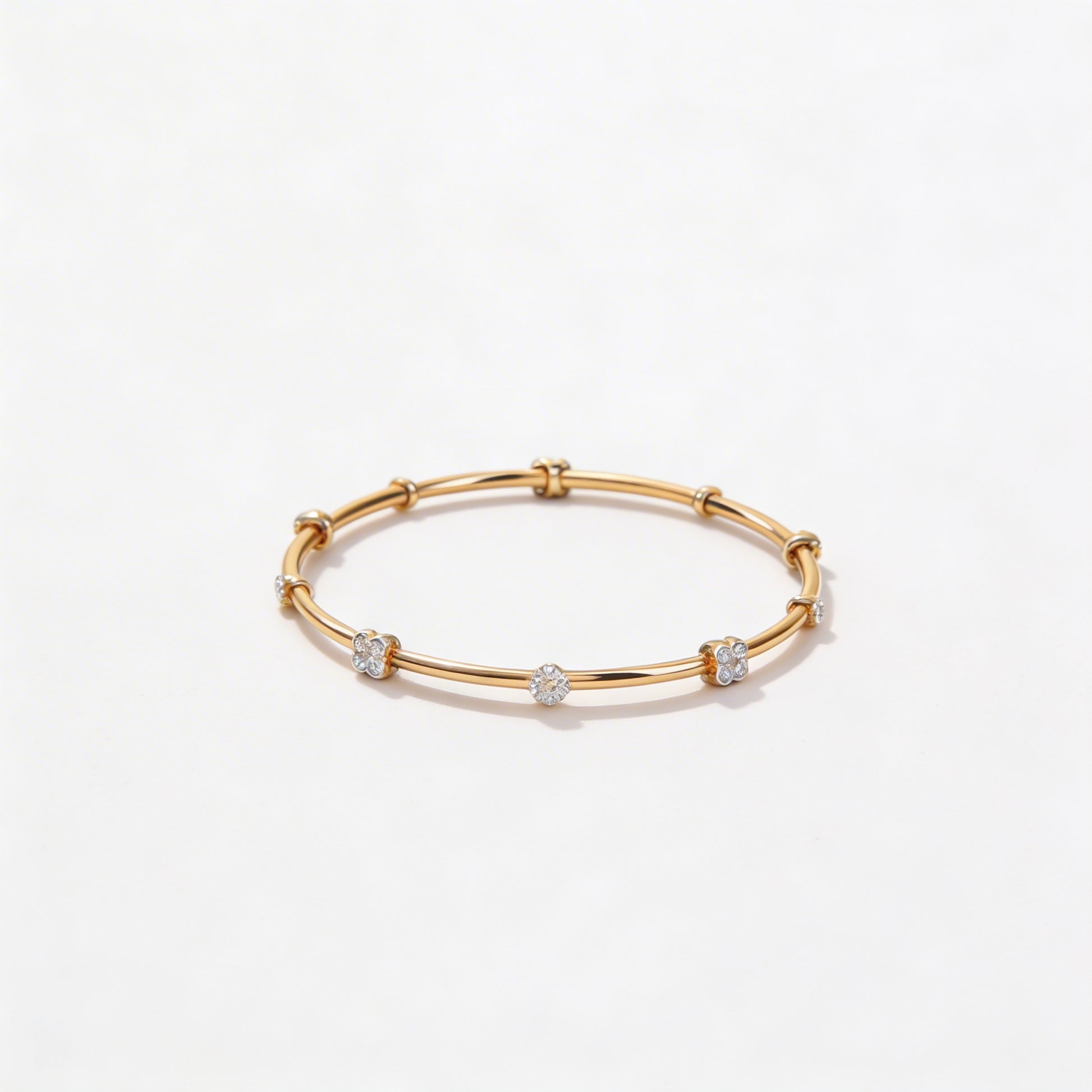Gold bracelet with small diamonds on a white background