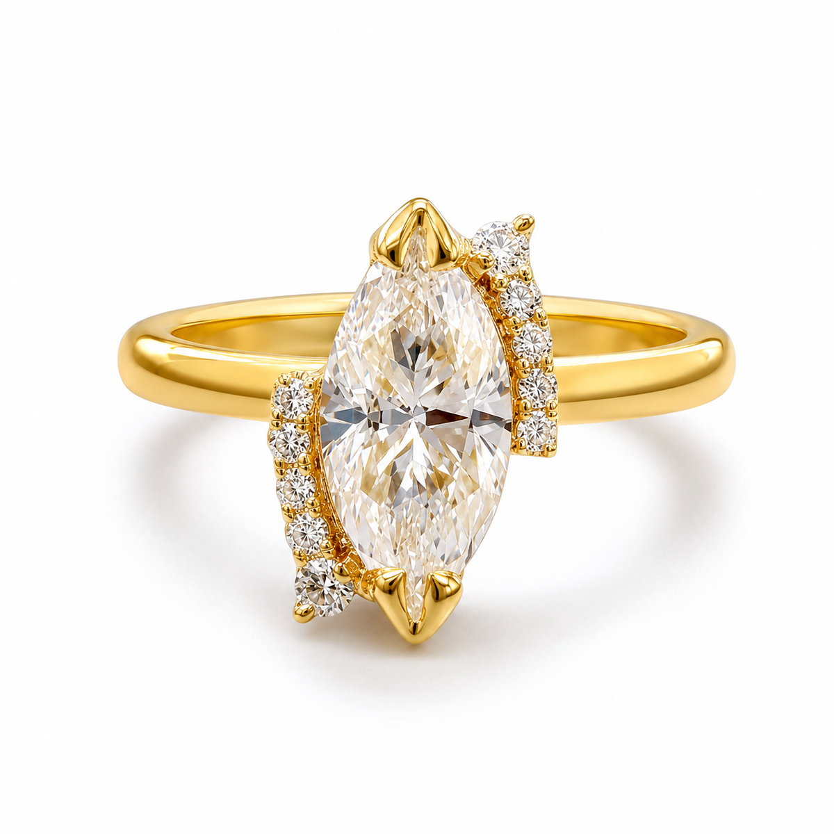 A yellow gold ring featuring a marquise-cut clear gemstone in a prong setting, accented by small pavé diamonds on the shoulders