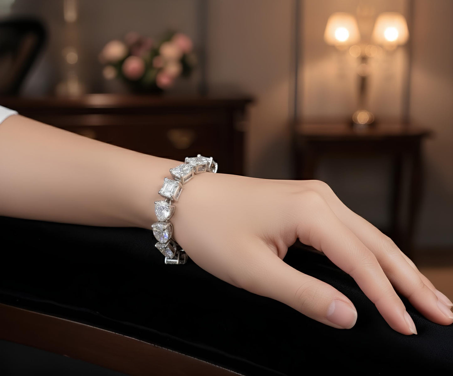 Hand wearing a diamond bracelet with a blurred background