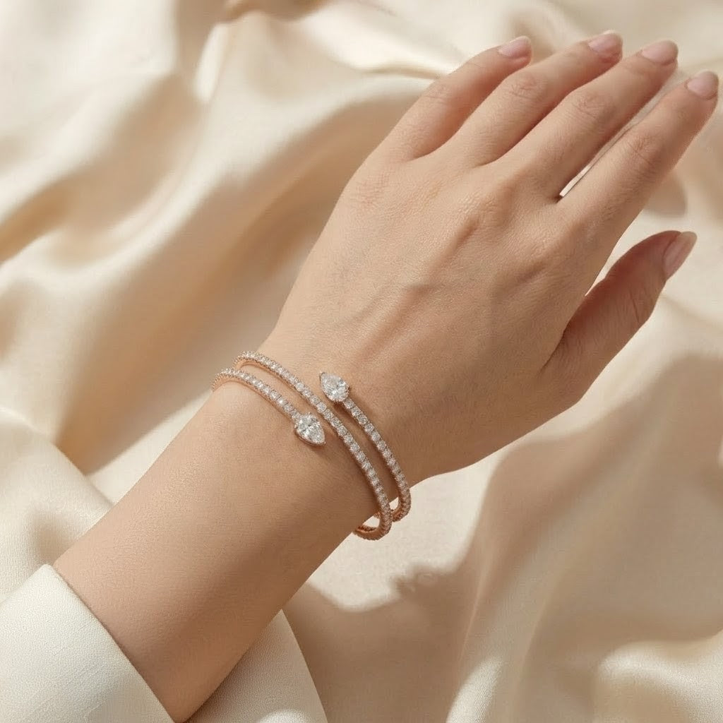 Hand wearing a bracelet on a beige fabric background