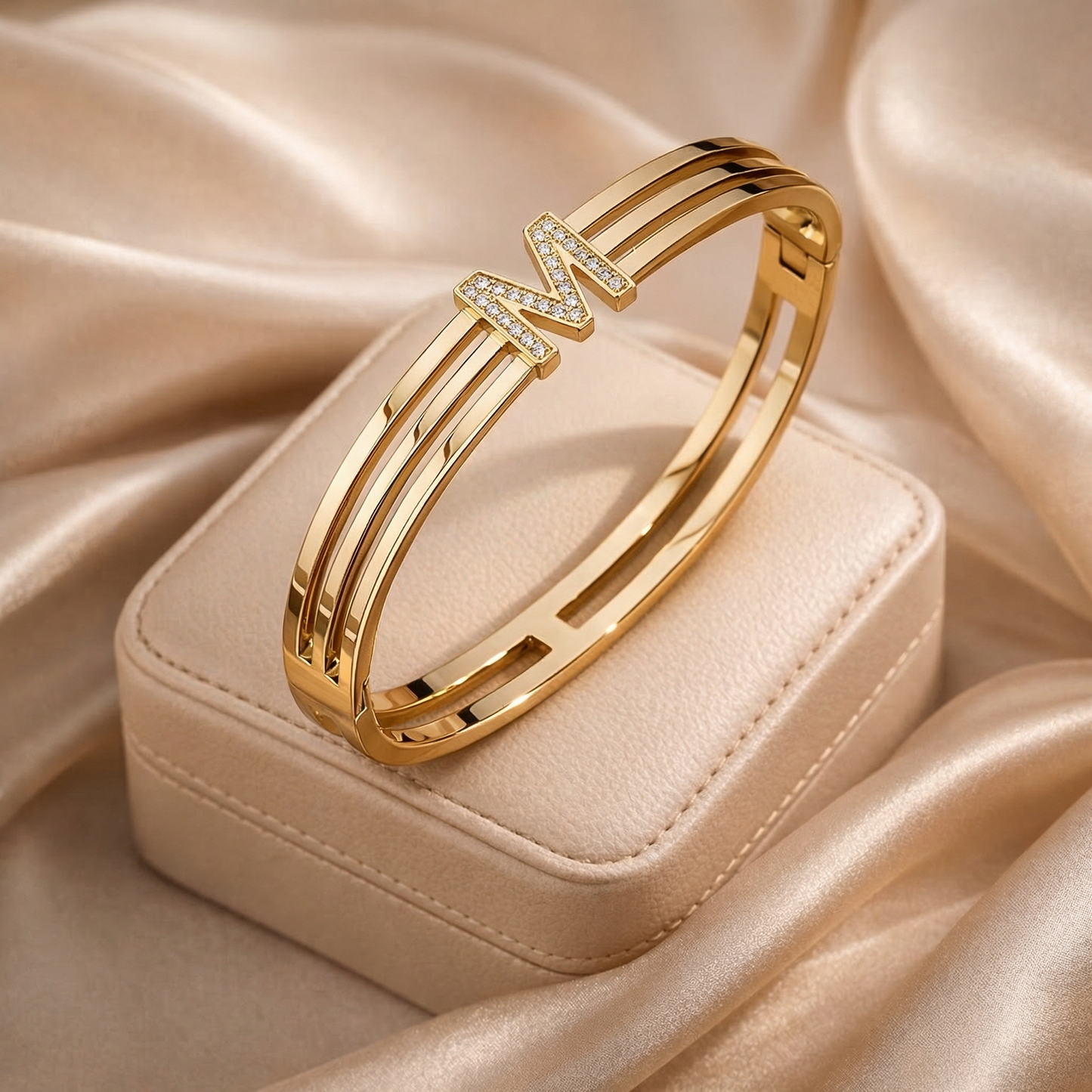 Gold bracelet with 'M' charm