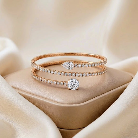 Rose gold bracelet with diamond accents on a beige fabric background