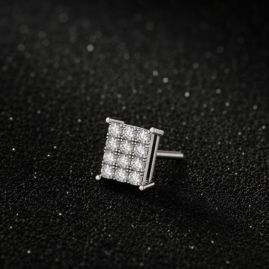 Silver square-shaped earring with clear stones on a black textured background